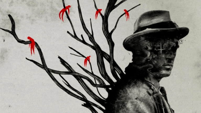 Thomas Richardson standing in front of a leafless tree with bodies pierced by its branches.