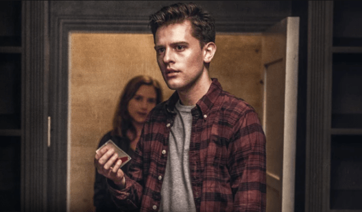 Jude holding a playing car while June stands in the closet in the film Seven in heaven